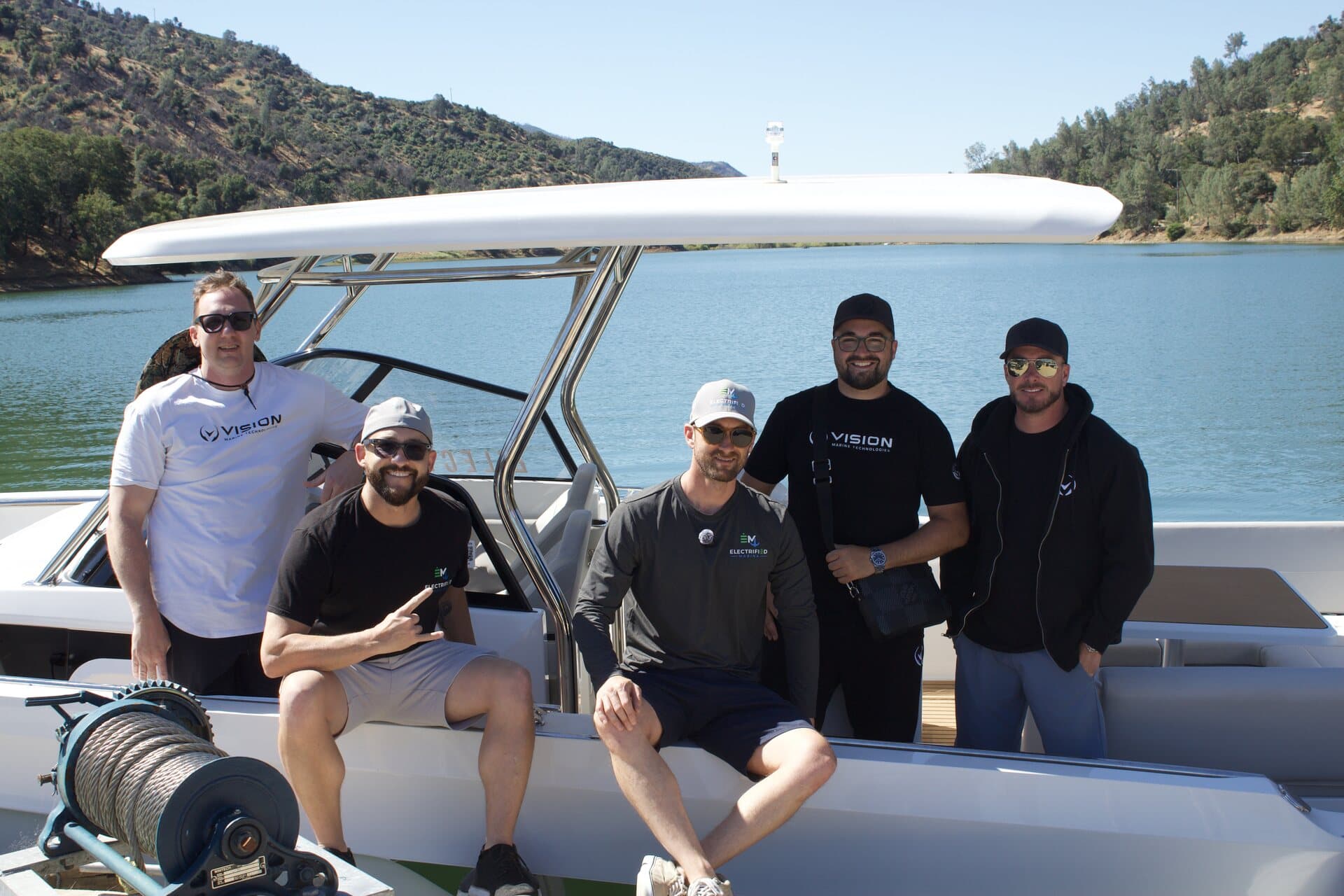 Electric boat demo team aboard a boat on the lake