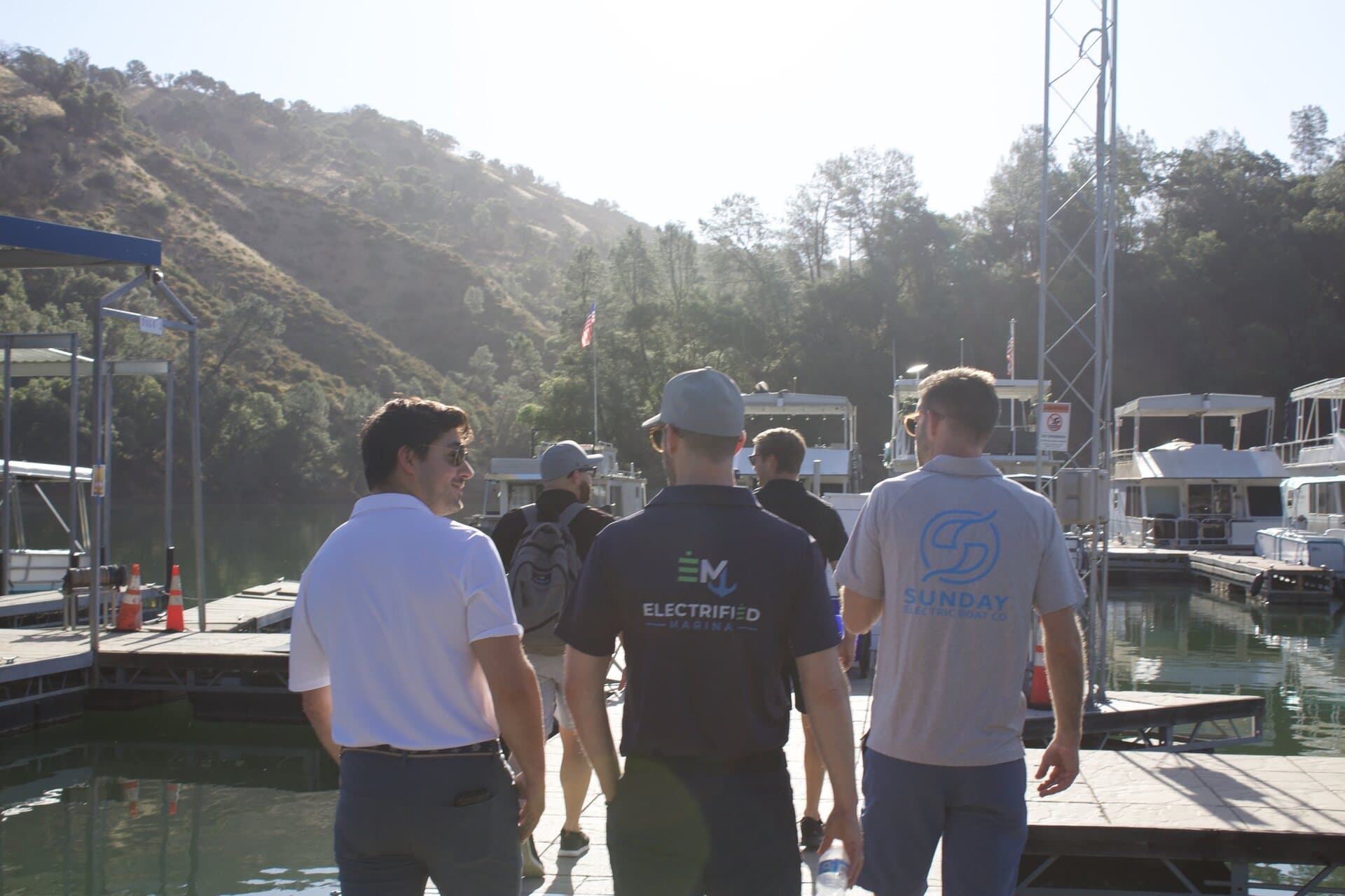 Guests gathering for an electric boat event at the dock