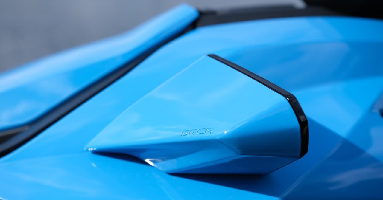 Close-up of the blue Taiga Orca WX3 electric personal watercraft, showing its angular body panels and raised side detail.