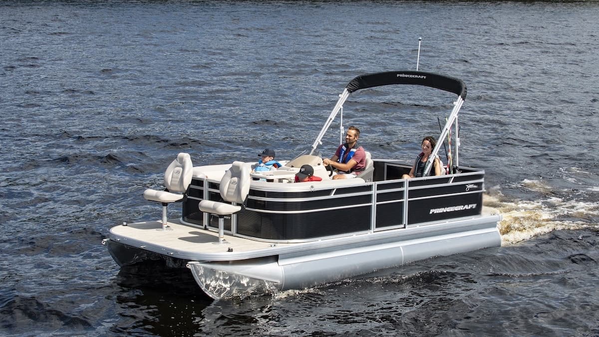 four people on board of a black pontoon with seats in the front and bimini top on